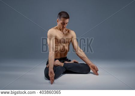 Male yoga maditates in classical pose