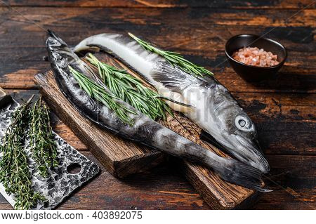 Whole Fresh Raw Icefish On A Wooden Cutting Board. Wooden Background. Top View