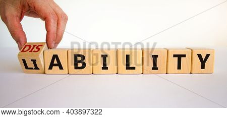 Liability Or Disability Symbol. Businessman Turns Cubes And Changes The Word 'liability' To 'disabil