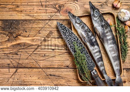 Raw Mackerel Icefish In A Wooden Tray. Wooden Background. Top View. Copy Space