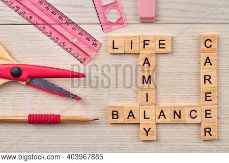 Top View Of Crossword With Career Balance Concept. Stationery And Wooden Blocks With Letters On The 