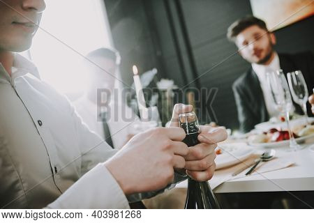 Group Of Friends Gathering Around Coffee Table At Home. Friends Gathered At The Table And Drinking B