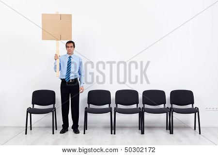 Lonely Protesting Businessman Or Employee Holding Placard