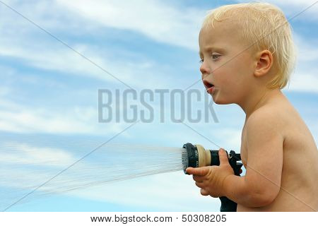 Baby Playing With Garden Hose