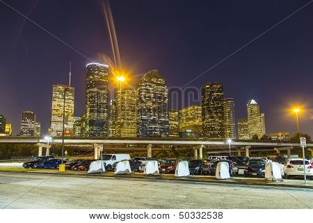 HOUSTON USA - JULY 10: View on downtown Houston in the night from the central parking lot on July 10 2013 in Houston USA. late afternoon with skyscraper Parking is free from 6pm to 8 am and all Saturday.