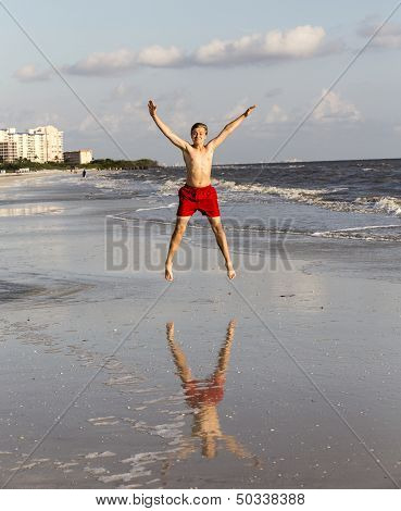 Teenager Enjoys Jogging Along The Beach