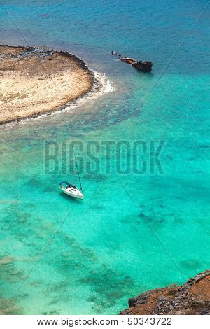 Beautiful tropical lagoon with yacht and pirate ship, Gramvousa island, Greece 
