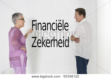 Couple discussing financial security against white wall with Dutch text "financiele\ zekerheid"