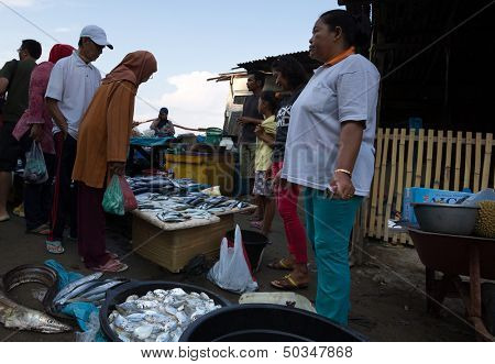 PADANG - AUGUST 25: Fishmongers wait for customers in a stall at an outdoor village market in Padang, West Sumatera, Indonesia on August 25, 2013. Resources from the sea is a major revenue earner.  