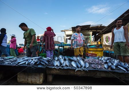 PADANG - AUGUST 25: Fishmongers wait for customers in a stall at an outdoor village market in Padang, West Sumatera, Indonesia on August 25, 2013. Resources from the sea is a major revenue earner.  