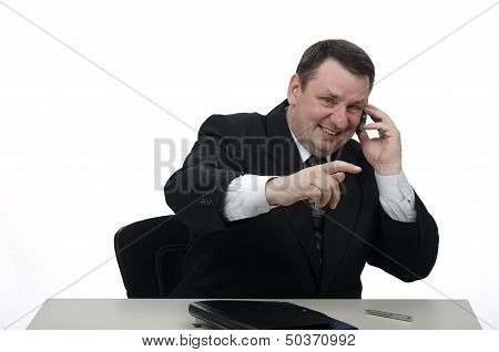 Smilling Middle-aged Businessman On The Phone In Office