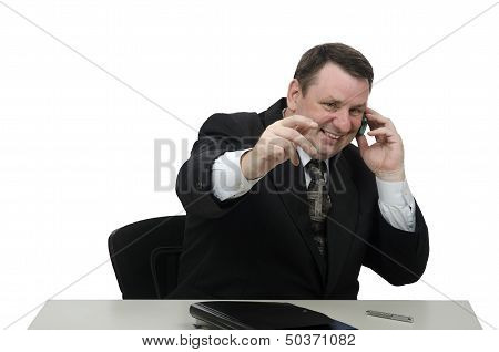 Laughing middle-aged office worker talking on mobile phone