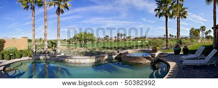 Panoramic view of swimming pool, hot tub and golf course