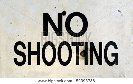 Damaged No Shooting Sign