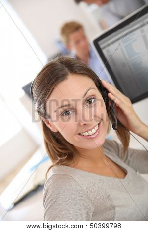 Beautiful smiling teleoperator with headset on 