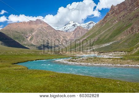 Blue river and snow peaks of Tien Shan mountains