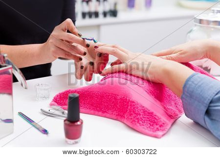 Nail saloon woman with hand manicure cuticle scraper pusher spoon tool
