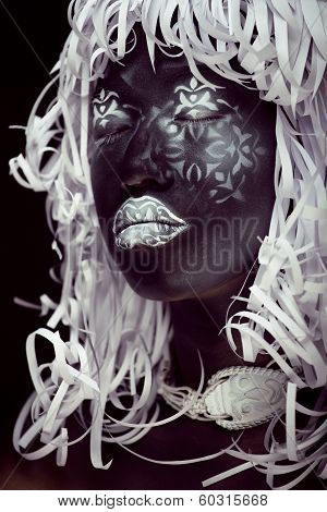 creative make up like Ethiopian mask, white pattern on black face close up