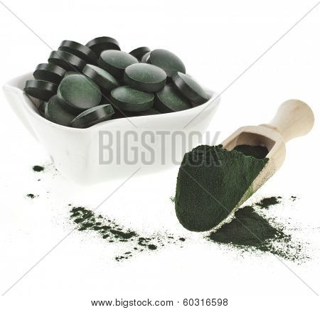 Spirulina algae  powder and tablets in spoon , isolated on white background 