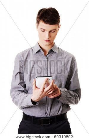 Young businessman using tablet computer isolated on white background