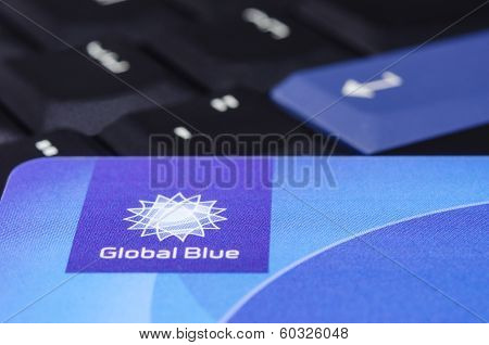 Global Blue Closeup Logo On Plastic Card Against Black Thinkpad Keyboard