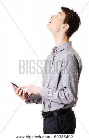 Young businessman using tablet computer isolated on white background