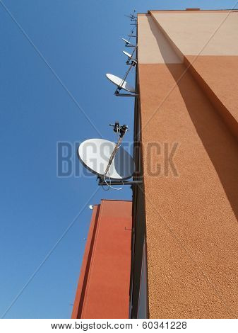 Prefab wall with satellites and blue sky