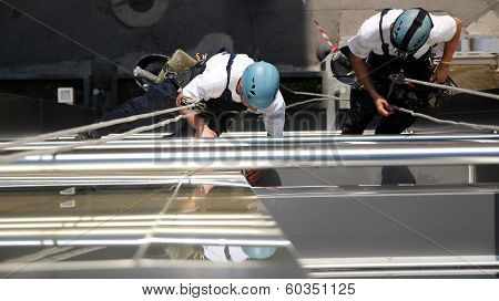 Climbers On Office Building