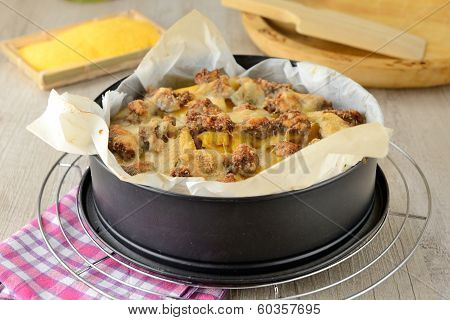 typical Italian dish botched polenta with melted butter and pieces of sausage