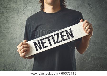 Man Holding White Banner With Word Netizen Printed