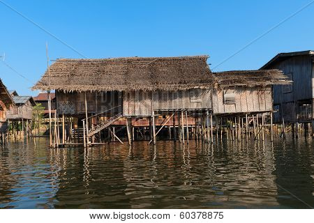 Traditional Stilts House In Water Under Blue Sky