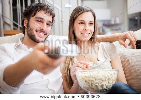 Young couple preparing to watch a movie