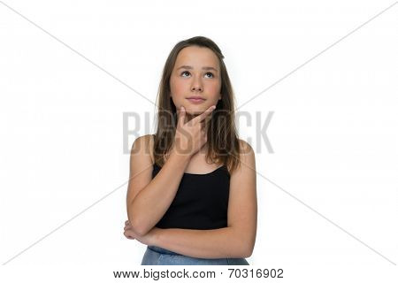 Young girl standing thinking with her hand to her chin looking up into the air with a contemplative expression, isolated on white