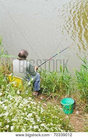Fisherman Catches A Fish From Riverbank