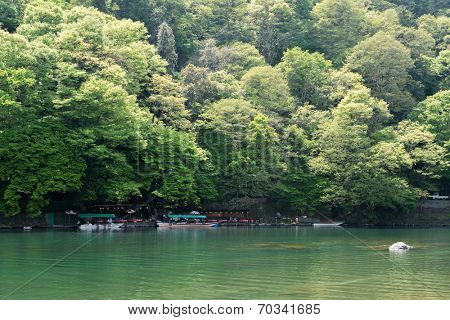 KYOTO, JAPAN - APRIL 26th  : Geen water and boats at the shore of Hozu (Katsuragawa) River in Arashiyama in Kyoto, Japan on 26th April 2014.