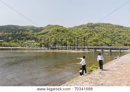 KYOTO, JAPAN - APRIL 26th  : Students throw stones at the shore of Hozu (Katsuragawa) River in Arashiyama in Kyoto, Japan on 26th April 2014.