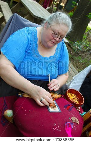 MUSKOGEE, OK - MAY 24: Women show art of lace making, as it was made in the Middle Ages, at the Oklahoma 19th annual Renaissance Festival on May 24, 2014 at the Castle of Muskogee in Muskogee, OK 