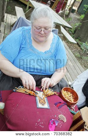 MUSKOGEE, OK - MAY 24: Women show art of lace making, as it was made in the Middle Ages, at the Oklahoma 19th annual Renaissance Festival on May 24, 2014 at the Castle of Muskogee in Muskogee, OK 