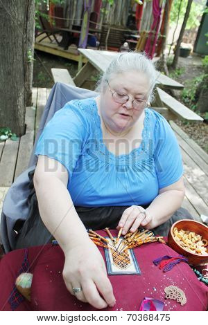 MUSKOGEE, OK - MAY 24: Women show art of lace making, as it was made in the Middle Ages, at the Oklahoma 19th annual Renaissance Festival on May 24, 2014 at the Castle of Muskogee in Muskogee, OK 