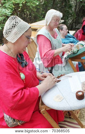 MUSKOGEE, OK - MAY 24: Women show art of lace making, as it was made in the Middle Ages, at the Oklahoma 19th annual Renaissance Festival on May 24, 2014 at the Castle of Muskogee in Muskogee, OK 