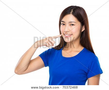 Asian woman finger point to teeth