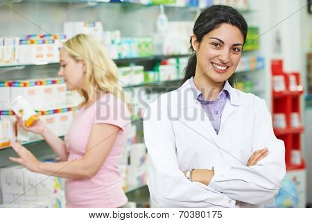 portrait of cheerful pharmacist chemist woman in pharmacy drugstore