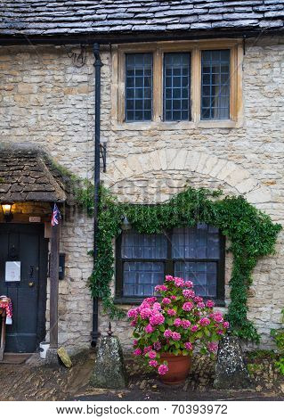 WILTSHIRE, CHIPPENHAM, UK - AUGUST 9, 2014: Castle Combe, unique old English village with luxury hot