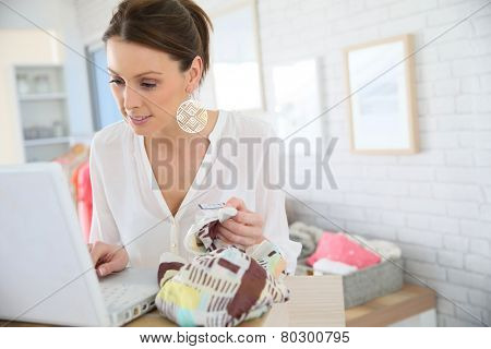 Beautiful shopgirl working in clothing store