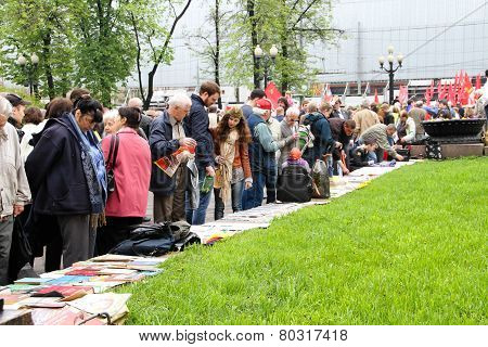 Participants Of Communistic Procession Consider The Political Press And Books