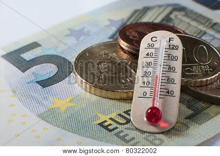 Five Euro Banknote With Some Coins And A Thermometer