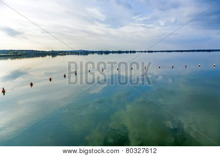 weir at altmuehl lake in late afternoon with scenic reflection