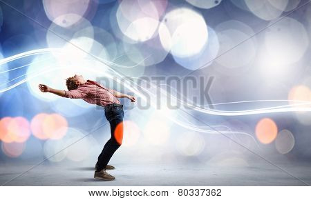 Young guy in casual evading from light rays