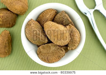 Brazil Nuts In Bowl With Nut Cracker