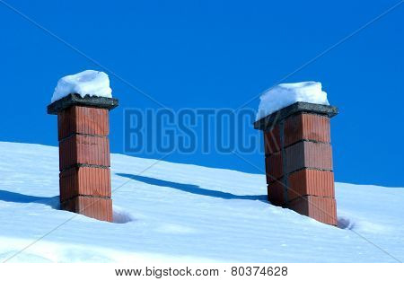 Rooftop Chimneys Under Snow